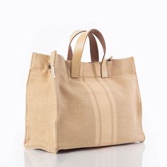 Natural eco-chic jute tote, seamlessly blending style and sustainability with leather handles for a touch of sophistication. Contains a magnetic closure, canvas interior lining, genuine leather handles with a 4" drop, an inner zip pocket and reinforced bottom support. Natural Satchel Tote With Rolled Handles, Natural Tote Bag With Leather Handles, Textured Leather Tote Satchel For On-the-go, Eco-friendly Satchel Tote With Leather Handles, Eco-friendly Tote Shoulder Bag With Leather Handles, Satchel Tote Bag, Jute Totes, Satchel Tote, Eco Chic