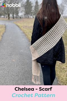 a woman walking down a path wearing a crochet scarf with text overlay that reads, chelsea - scarf crochet pattern