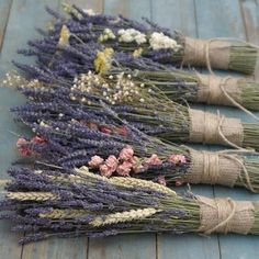 three bundles of dried lavender on a wooden table