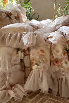 a bed with ruffles and flowers on it