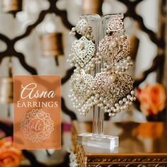 Celebrate your beauty and look phenomenal by wearing our Asna Earrings! Exquisite dangle earrings embellished with CZ stones and beads. Approximate earrings length is 4". Gold-plated on high-quality brass as base metal. In-stock & ready-to-ship. *Please Note: We use faux stones and beads in all of our jewelry. Faux Stone, Cz Stone, Base Metal, Indian Jewelry, Ruby, Pearl Earrings, Gold Plate, Dangle Earrings, Crown Jewelry