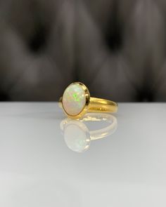 Certificated Natural Opal Dainty Cabachon Ring * 14K Solid Gold & Genuine Opal Stone * Best Gift for her * Handmade Ring ◎ Details ◎ ○ Gemstone Details .Natural OPAL Oval Cut 10.16X8.09 mm approx. 1.53 ct ○ Gold Details 14K Solid Gold Width of Band : 3.00 mm Weight of Ring : approx 4.60 gr Made to Order HANDMADE ITEM ○ Upgrade to Solid 18K Gold, please click the link below: https://www.etsy.com/listing/962826004 ◎ For more CABACHON BEZEL rings : http://etsy.me/37fvI60 All of our jewelleries Classic Cabochon Opal Ring, Gold 14k Opal Ring As Gift, 14k Gold Opal Ring For Gift, Oval Gold Opal Ring In 14k Gold, Heirloom Gold Opal Ring With Polished Finish, Elegant Gold Opal Cabochon Ring, Heirloom Gold Opal Ring With Cabochon, Heirloom Gold Opal Cabochon Ring, Luxury Gold Opal Ring Hallmarked