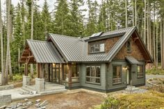 a small cabin in the woods surrounded by trees