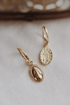 Gold filled 925 sterling silver stamped Mama Mary Miraculous Medal earrings. Dangling from secure sterling silver hoops for easy wear, the Miraculous Medals are solid and double sided. 🤍🕊️