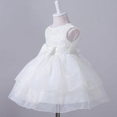 A beautiful white formal occasion dress for your baby girl. Ideal for Christenings, weddings and parties. Elegant White Sleeveless Ball Gown, Elegant Sleeveless White Ball Gown, Lace Princess Dress With Ruffles For Wedding, White Lace Ball Gown With Ruffles, White Sleeveless Ruffled Ball Gown, Elegant Princess Dress With Ruffles For First Communion, Elegant Sleeveless Lace Trim Tutu Dress, Elegant Sleeveless Princess Dress With Lace Trim, Elegant Sleeveless Lace Princess Dress