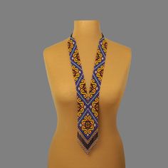 "A yellow and blue necklace is a stylish and original jewelry. A seed bead necklace will make you more tender and sophisticated. An elegant necklace will be a wonderful birthday gift for your wife. Despite the size, the bead necklace is light.  A long necklace is a versatile accessory that can complement any outfit, regardless of style. All handmade jewelry in our assortment is unique. Each product has its style and original design. Nevertheless, many jewelry pieces are easily combined, creating an unforgettable image. ------------------ The hippie jewelry is one of the best gift ideas. At SweetBeadsIP, you will find a gift for everyone - a gift for a girlfriend, a gift for a mother, a gift for a sister, or a gift for a daughter. The necklace is made of colorful Czech beads carefully threa Elegant Yellow Jewelry With Tiny Beads, Elegant Yellow Beaded Necklaces With Tiny Beads, Blue Long Beaded Necklace With Tiny Beads, Blue Beads With Gold Details As A Gift, Yellow Bohemian Necklace With 108 Beads, Blue And Gold Beads For Gifts, Yellow Necklace With 108 Beads As Gift, Elegant Yellow Beaded Chain, Elegant Yellow Long Beaded Necklaces