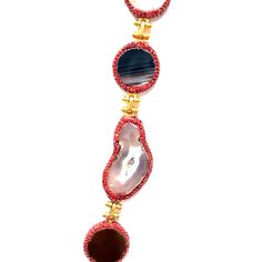 This exquisite necklace showcases a harmonious blend of vibrant gemstones, each radiating its unique charm. The centerpiece is a striking large blue stone, perfectly complemented by an array of smaller multicolored stones, all set in delicate gold settings. Ideal for adding a pop of color and elegance to any outfit. Luxury Red Jewelry With Gemstone Accents, Multicolor Pendant Necklace In Fine Jewelry Style, Luxury Multicolor Necklace With Gemstone Accents, Luxury Multicolor Gemstone Necklaces, Luxury Multicolor Necklaces With Gemstone Accents, Luxury Multicolor Multi-stone Necklaces, Fusion Multi-stone Round Necklace, Luxury Multicolor Stone Jewelry, Luxury Gemstone Necklaces For Parties