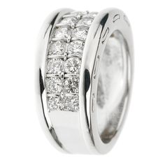 a white gold ring with diamonds on the sides and in the middle, it is surrounded by two rows of round brilliant cut diamonds