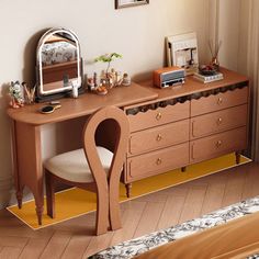 a bedroom with a dresser and mirror on the wall, next to a bed in it