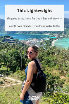 a woman standing on top of a lush green hillside next to the ocean with text that reads, this lightweight sling bag is my go - to for day hikes and travel