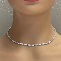 A classic and elegant everyday or occasional wear with same size diamonds all around, this Tennis Necklace is a timeless and versatile piece of jewelry. All our necklaces have two locks for added security. Total Diamond Weight: 10.02 ctNo. of Diamonds: 122 Average Diamond Weight: 0.08 ct Diamond Color: G - H Diamond Clarity: VVS - VS (Very Very Slightly Included - Very Slightly Included) Metal: 18K White Gold Metal Wt: 17.05 gms Setting: Prong Set Length: 16 Inches (40.64 cm) Length may be adjus Elegant Sterling Silver Tennis Necklace With Single Cut Diamonds, Elegant Silver Tennis Necklace With Single Cut Diamonds, Formal Tennis Necklace With Single Cut Diamonds, Timeless Sterling Silver Tennis Necklace For Formal Occasions, Formal Sterling Silver Tennis Necklace With Diamond Accents, Formal Brilliant Cut Cubic Zirconia Tennis Necklace, Formal Fine Jewelry Tennis Necklace With Single Cut Diamonds, Dazzling Sterling Silver Tennis Necklace For Formal Events, Elegant White Gold Tennis Necklace With Single Cut Diamonds