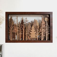 a wooden cutout of trees in a frame