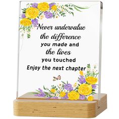 a glass plaque with flowers on it and the words never undervalue the reference you made and the lives you touched