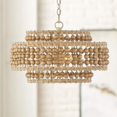 a wooden beaded chandelier hanging from a ceiling