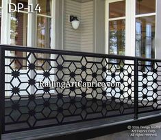 an iron railing on the front porch of a house