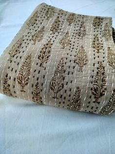 a close up of a cloth bag on a white tablecloth with brown and tan designs