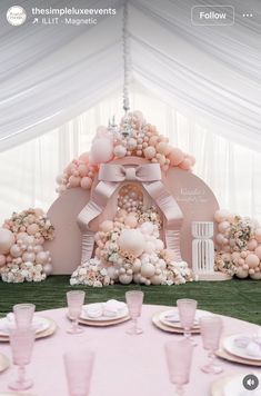 the table is set with plates and place settings for an elegant wedding reception in pastel pinks