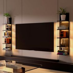 a living room with a large flat screen tv mounted on the wall and shelves above it