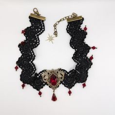 This vintage gothic styled crystal choker necklace features captivating Siam Red Swarovski crystals with nice crisp facets and brass embellishments. The detailed stampings have been in production since the 1940's and the vintage 16x11mm focal crystal is no longer in production, making this necklace a rare find. The lace is double-layered and hand sewn together for extra durability. Both elegant and stylish, this piece would be perfect for any formal occasion. Swarovski Crystals are made in Austr Lace Choker Necklace, Crystal Lace, Lace Choker, Crystal Choker Necklace, Vintage Gothic, Crystal Choker, Red Crystals, Gothic Jewelry, Jewelry Vintage