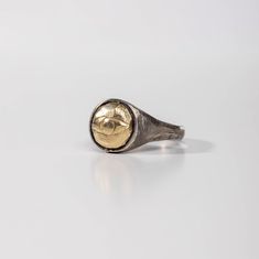 A signet ring for men and women in brutalist style with a protection evil eye made of 14K solid gold. This rustic pinky ring is handcrafted of sterling silver 925 that is oxidized. It can is a great choice for a Christmas gift for him or for her. --- MATERIALS & DIMENSIONS --- * High Quality 925 Sterling Silver and 14K Solid Gold * Black Oxidized finish * Width: 13mm --- SHIPPING --- All orders are shipped via FedEx Express (delivery time 3-5 days to the US, 1-3 days to Europe). Please note that Hand Forged Metal Rings, Unique Handmade White Gold Signet Ring, Antique Dome Ring With Polished Finish As Gift, Gift Dome Ring With Polished Finish, Symbolic Brass Rings For Formal Occasions, Tarnish Resistant Metal Signet Ring As A Gift, Vintage Adjustable Signet Ring Tarnish Resistant, Handmade Symbolic Yellow Gold Rings, Hand Cast Signet Ring As Gift