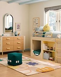 a child's bedroom with bunk beds, dressers and other furniture in it