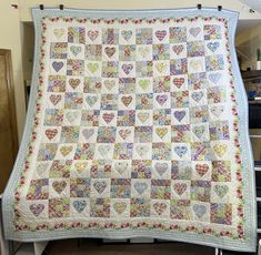 a large quilt with many hearts on it