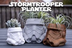 three star wars planters sitting on top of a table