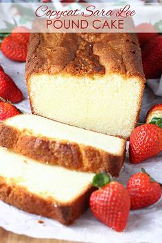 sliced loaf of pound cake with strawberries on the side