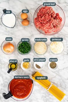 the ingredients for an italian meatball recipe laid out on a marble counter top