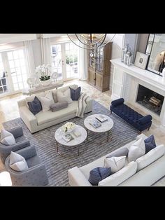 an aerial view of a living room with couches, chairs and fireplace in it