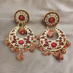 Enhance your look with these elegant Coral Chandbali Earrings. Featuring intricate designs with coral drops, these earrings bring a perfect blend of tradition and sophistication to any outfit. Ideal for festive occasions, they add a vibrant and graceful touch to your ensemble. Length: 3" to 3.5" Material: 24Kt gold foil, lac Stones: Kundans, semi precious corals, semi precious pearls Chandbali Earrings, Coral Flowers, Pin Pendant, 24kt Gold, Pendant Rings, Intricate Designs, Natural Beads, Gold Foil, Necklaces Bracelets