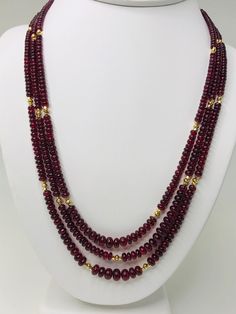 This strand of fine quality spinel beads would be at home in a 19th century ballroom or a 21st century boardroom! Rich, pomegranate red oval rondelles have been hand strung with 22k yellow gold spacers and an 18k yellow gold clasp in an elegant 19-inch strand. I have never seen red spinel beads before! Spinels have often been mistaken for fine rubies throughout history and looking at this strand, it is easy to see why. The beads, graduating in size from 3.00 to 6.50 millimeters, are of the fines Ruby Necklace Designs, Amber Bead Necklace, Red Spinel, Ruby Beads, Pearl Jewelry Sets, Beaded Jewelry Designs, Ruby Necklace, Amber Beads, Strand Necklace