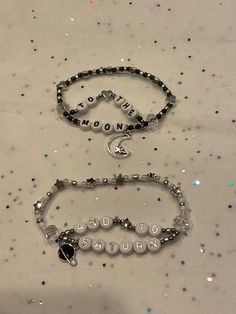 "Matching set of bracelets with the lyrics \"to the moon and to Saturn\" on them. Can be made to a certain length with stretchable string. The current charms are seen in the second picture. The bracelet can be done in gold or silver with the planet either being black or white. Please note that these bracelets will be made to order." Love You To The Moon And To Saturn Bracelet, To The Moon And To Saturn Bracelet, Exile Bracelet Taylor Swift, Tiny Bead Bracelet Patterns, Moon And Saturn Bracelet, Beaded Bracelets Friendship, Friendship Bracelets With Charms, Matching Friendship Bracelets Beaded, Cute Bracelet Ideas Bead