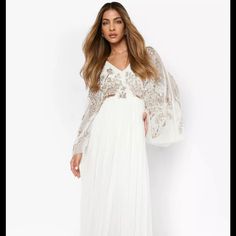 Embellished Ivory Gown For Wedding, Bridesmaids White Evening Dress For Wedding Guest During Prom Season, Glamorous V-neck Wedding Gown, Cream Floor-length Prom Dress, White Embellished V-neck Evening Dress, White Gown With Sheer Bodice For Prom Season, V-neck Maxi Dress With Sheer Bodice For Wedding, Sheer Bodice Maxi Length Wedding Dress, Sheer Bodice Maxi Wedding Dress, Wedding Dress With Sheer Bodice And Maxi Length