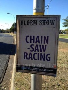 a sign on a pole that says chain saw racing is why i'll live