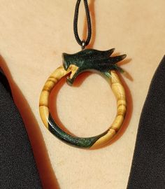 This is a 100% handmade Resin & Stabilized Olive Wooden necklace. I'm proud to have this handmade necklace in my shop. This Ouroboros Dragon pendant will make a perfect unique gift for Christmas, i will send it in a nice gift box. This necklace is made of Resin & Stabilized Wood and completely handcrafted. Every detail is carefully handcarved. Cord is adjustable Ready and packed for shipping, what you see is exactly what you get. Please contact me for custom order. Adjustable Nature-inspired Necklace For Gift, Adjustable Hand Painted Nature-inspired Jewelry, Hand Painted Green Spiritual Jewelry, Nature-inspired Round Necklaces For Jewelry Making, Green Hand Painted Spiritual Jewelry, Spiritual Hand Painted Green Jewelry, Nature-inspired Round Necklace For Gifts, Nature-inspired Round Necklace For Gift, Hand Painted Nature-inspired Necklace For Gift