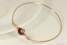 Gold Garnet Red Swarovski Crystal Bracelet Handmade by Jessica Luu Jewelry ~ Alluring ~ Versatile ~ Elegant ~ With every wave of your hand, there will be a sparkle of blood red at your wrist as this bangle moves around. Garnet is the birthstone for January making this a thoughtful birthday gift for someone special. MATCHING ITEMS https://www.etsy.com/shop/JessicaLuuJewelry?ref=seller-platform-mcnav&search_query=garnet+siam MATERIALS: ~ 10mm siam Swarovski crystal ~ 14K gold filled wire HOW I Garnet Bangle Jewelry Gift, Red Adjustable Wire Wrapped Bracelets, Gold Metal Wire Wrapped Bangle, Elegant Wire Wrapped Crystal Bangle Bracelet, Yellow Gold Wire Wrapped Bangle, Garnet Red, Garnet Bracelet, Swarovski Crystal Bracelet, Swarovski Crystal Jewelry