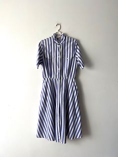 "Vintage Shirt Dress Button down 90's Summer Dress Purple White Striped Dress Short Sleeve Dress Comfortable Dress Medium Size Dress Estimated size: M Measurements (lying flat): Shoulders: 16\"/ 40.5 cm Bust: 19.5\" / 49.5 cm Width: 15\"/ 38 cm Sleeve: 10\"/ 25.3 cm Length total: 45\"/ 114.3 cm Condition: Very Good Vintage Condition Please check measurements to insure a proper fit. Remember to allow yourself some extra room for movement. You can compare these with something from your closet that fits you well. This dress will come to you freshly laundered and ready to wear. Please convo me if you need additional measurements. SHIPPING * I ship worldwide via Priority mail (Latvijas Pasts) from Latvia (EU). * I ship from Europe, so please allow 2 to 4 weeks for the package to arrive if you l Classic Button-up Shirt Dress For Summer, Classic Summer Shirt Dress With Button Closure, Classic Button-up Dress For Daywear, Classic Striped Button-up Shirt Dress, Classic Summer Button-up Midi Dress, Classic Button-up Midi Dress For Summer, Striped Collared Shirt Dress With Button Closure, Summer Mid-length Shirt Dress With Button Closure, Striped Cotton Shirt Dress With Buttons