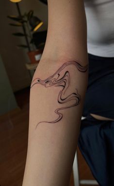 a woman's arm with a tattoo design on the left side of her body