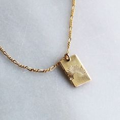 Our sun ray rectangle pendant necklace is a daily reminder to shine bright! Wear it alone or layer, it makes a great gift too! •Thick 19mm rectangle.•Choose your chain style.•100% 14kt Gold-Filled or Sterling Silver.•Stamped by hand with a sun ray Model is wearing 18 inch in photos & layered with our Unity Necklace Water friendly Rectangle Gold Necklace, Necklace Pendant Design, Minimal Gold Jewelry, Small Gold Necklace, Rectangle Pendant Necklace, 14kt Gold Jewelry, Rectangle Necklace, Preppy Jewelry, Sun Necklace