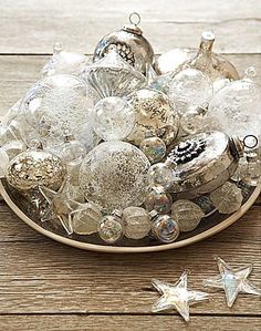 a bowl filled with ornaments on top of a wooden table