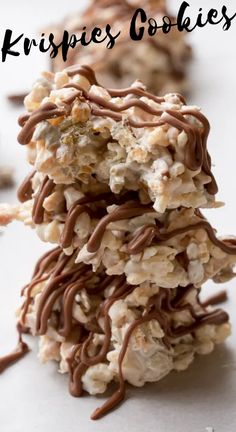 rice krispies stacked on top of each other with chocolate drizzle and nuts