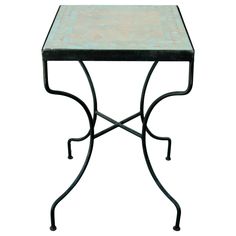 a small table with a square top and metal legs