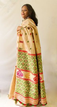 This is hundred percent authentic Muga Silk Saree . The interwoven motif yarns are in cotton and acrylic with touches of golden zari .  The design is very traditional and known as Kinkhap and one of the most iconic designs of the region. These kind of bright colour motifs with  Muga combination is always been part of bridal collections.  Muga Silk - The most valued silk from India. Almost exclusively reared and produced in Assam, India. It is indigenous to the Brahmaputra Valley and assiduously Unstitched Bohemian Traditional Wear With Woven Motifs, Multicolor Traditional Wear With Weaving For Eid, Unstitched Cotton Traditional Wear With Woven Motifs, Cotton Traditional Wear With Weaving Work, Traditional Cotton Drape With Weaving Work, Cotton Traditional Wear With Woven Motifs For Transitional Season, Diwali Cotton Traditional Wear With Weaving Work, Beige Bohemian Dupatta With Traditional Patterns, Bohemian Beige Traditional Wear For Festive Occasions