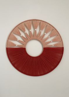 a red and white circular object hanging on the wall