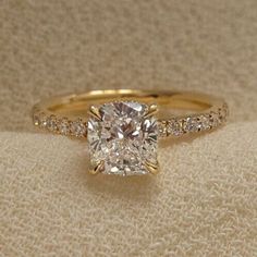 an engagement ring with a cushion cut diamond