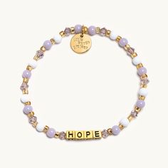 Hope is about finding light in the darkness. Let these lilac beads and tarnish-proof gold letters light the way. Set Kindness in MotionThe cycle of kindness starts with you. It’s why each of our bracelets has a trackable ID tag, so you can one day pass it on and pay its meaning forward. Connect your bracelet to get started! Engagement Games, Little Words Project, Letter Bead Bracelets, Chicago Gifts, Light In The Darkness, Light The Way, Friendship Bracelets With Beads, Light Letters, In The Darkness