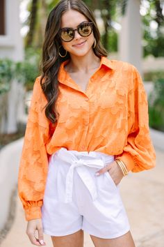 This timeless orange blouse is anything but ordinary. With a unique textured floral print and classic fit, you can truly stand out from the crowd. Long bubble sleeves give it an extra touch of sophistication. Elevate your wardrobe with a blouse that has all the details. Collared neckline Button down front closure Long bubble sleeves Textured fabric Tank lining No stretch Sydney is wearing the small. Elegant Orange Blouse For Fall, Orange Fall Blouse For Day Out, Orange Blouse For Fall Day Out, Chic Orange Fall Blouse, Elegant Orange Blouse For Work, Chic Orange Long Sleeve Blouse, Chic Orange Summer Shirt, Spring Orange Shirt For Day Out, Elegant Orange Tops For Fall