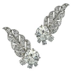 From the House of Cartier, these spectacular ear climber diamond earrings, circa 1940, are finely crafted in platinum and showcase 2 old European cut diamonds weighing approximately 9.25 carats,VS-SI clarity, detailed with 54 old European cut diamonds weighing approximately 3 carats total, VS-SI. The earrings are fashioned into mesmerizing leaves, dancing up the ear in a dazzling display of brilliance and fire.  These spectacular earrings were worn by the talented and beautiful  Pop Sensation, K Earrings Cartier, Diamond Chandelier Earrings, Diamond Chandelier, Ear Climber, Antique Chandelier, Ear Climbers, Gold Diamond Earrings, European Cut Diamonds, Antique Earrings