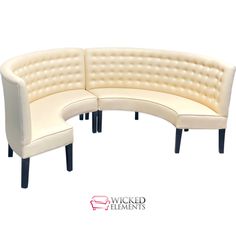 a curved couch with buttons on the back and legs, sitting in front of a white background